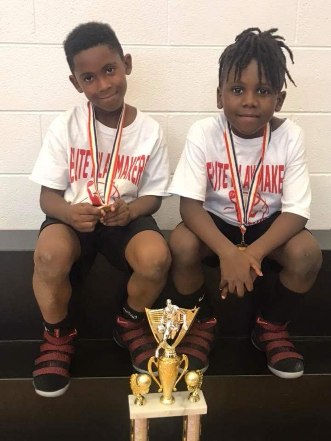 Elite Playmakers 2018 players with medals and a trophy