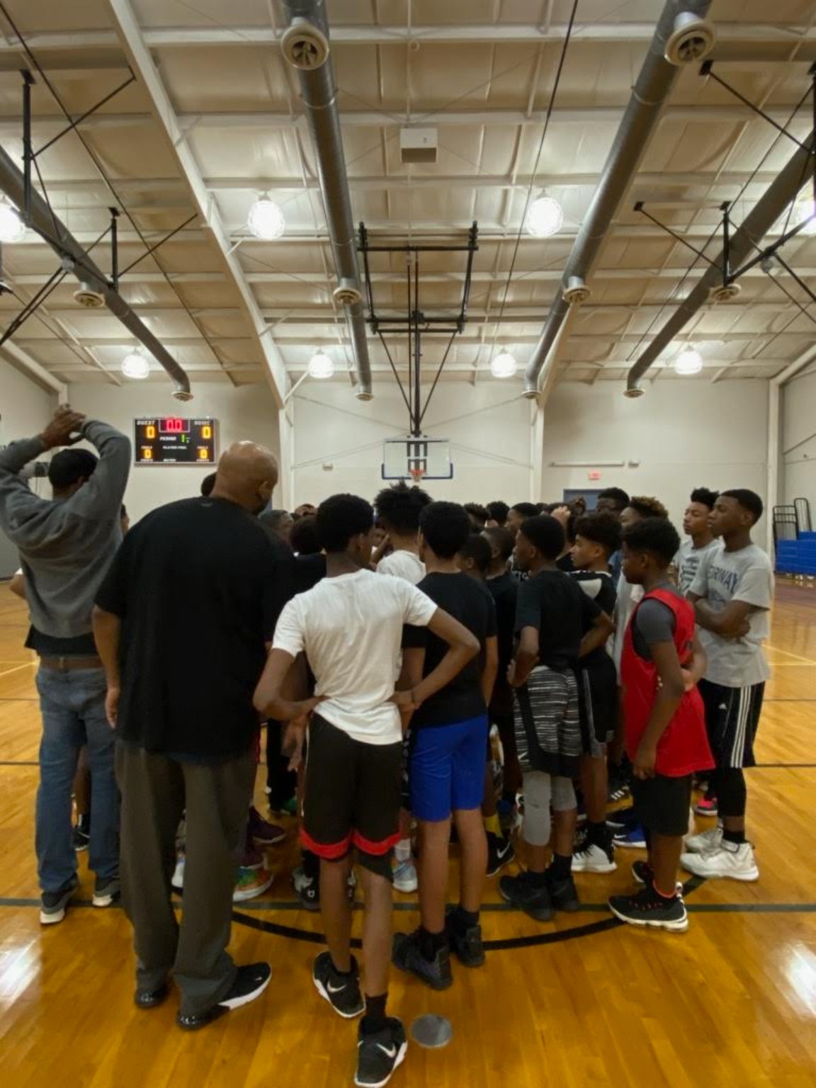 Elite Playmakers 2020 players and coaches in a team huddle