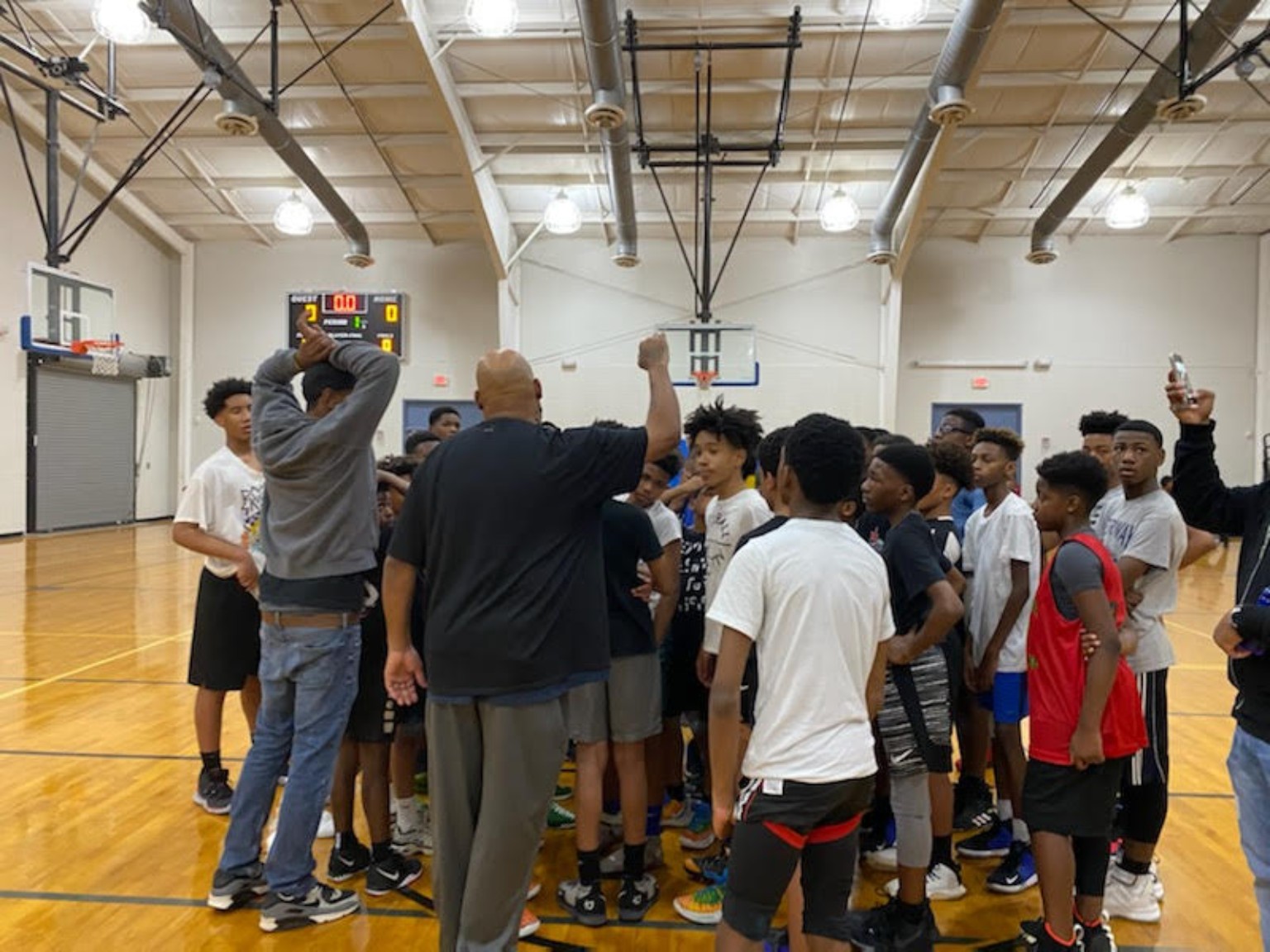 Elite Playmakers 2020 players and coaches in a court huddle