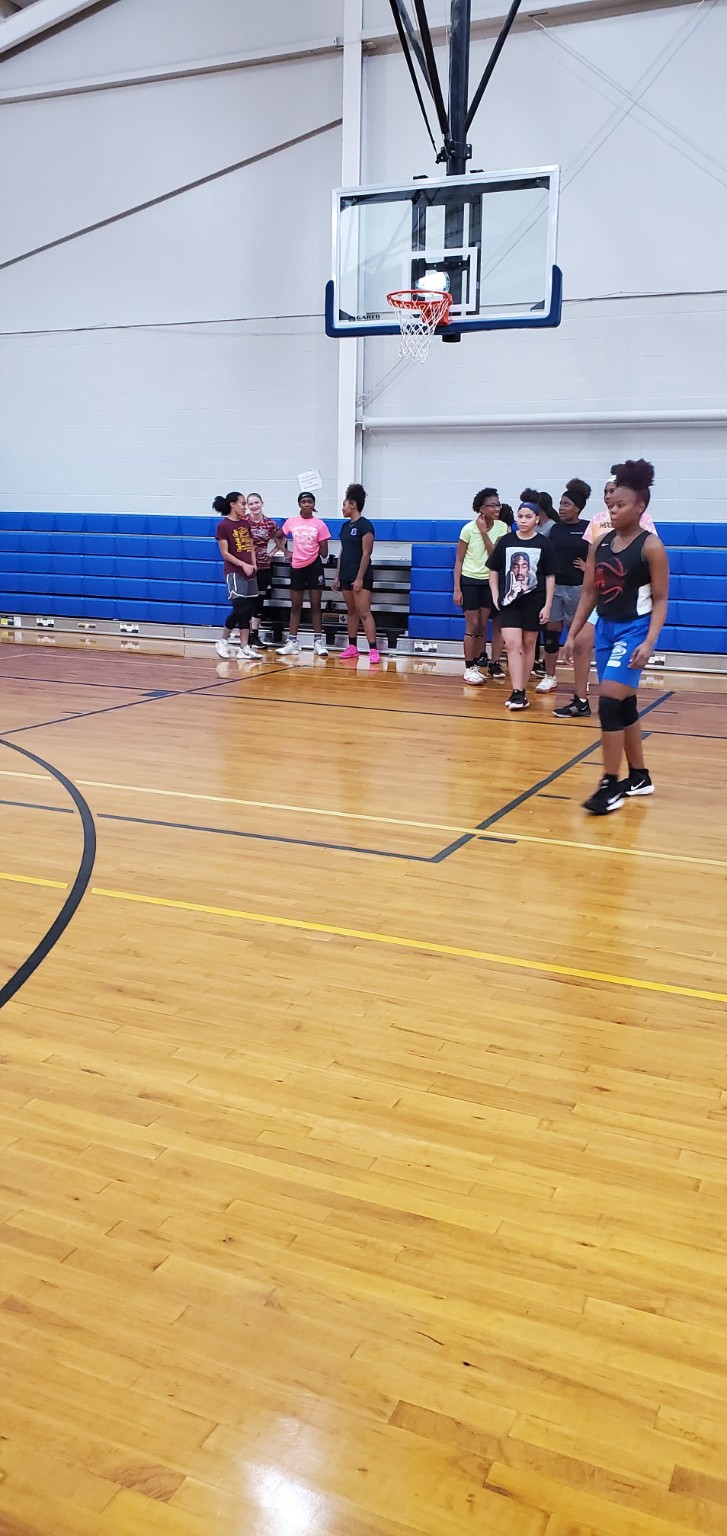 Lady Playmakers 2020 players gathered beneath the basket